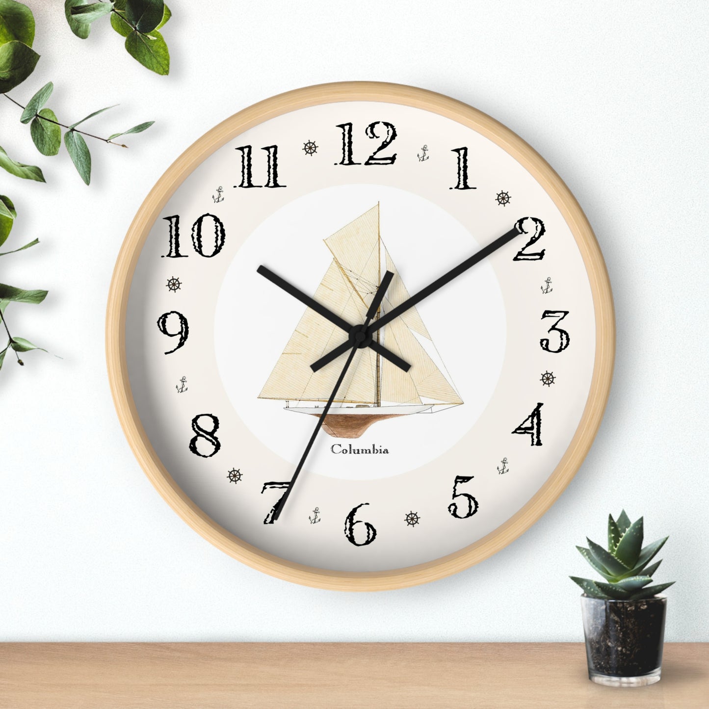 The Columbia Designer Clock features hand-drawn naval symbols between the numbers on the clock face. Hang this wall clock in any room for a unique decorator touch.