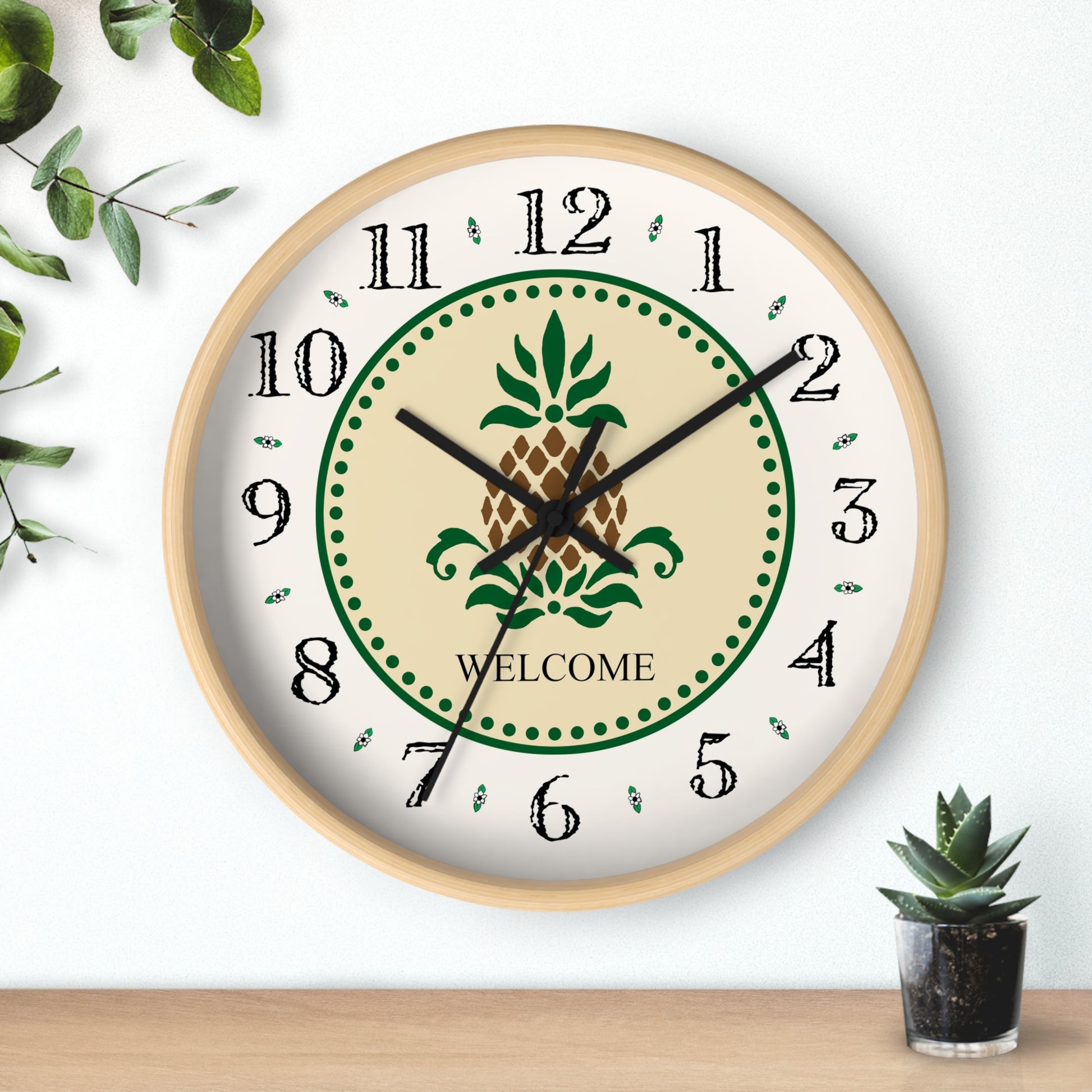 The Welcome Folk Art Design Heirloom Designer Collection Wall Clock features a pineapple and the word "Welcome". The pineapple has long been a symbol of welcome and hospitality. Place this stunning Folk Art Design clock on your wall and say "Welcome!" to all who visit and enjoy your special hospitality.   The clock image is a reproduction of an original watercolor by Lee M. Buchanan.