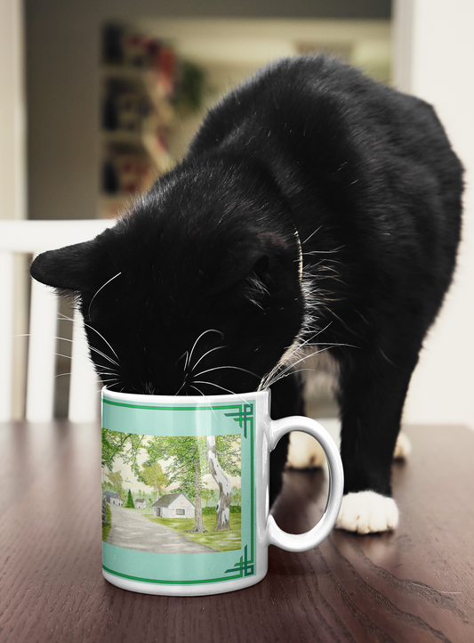 The Country Lane and Fence 15 oz. Mug holds your favorite beverage that is being enjoyed by this handsome black and white cat. He enjoys your tasty beverage and the country mug with its reproduction of a watercolor painting by artist and cat lover Lee M. Buchanan.